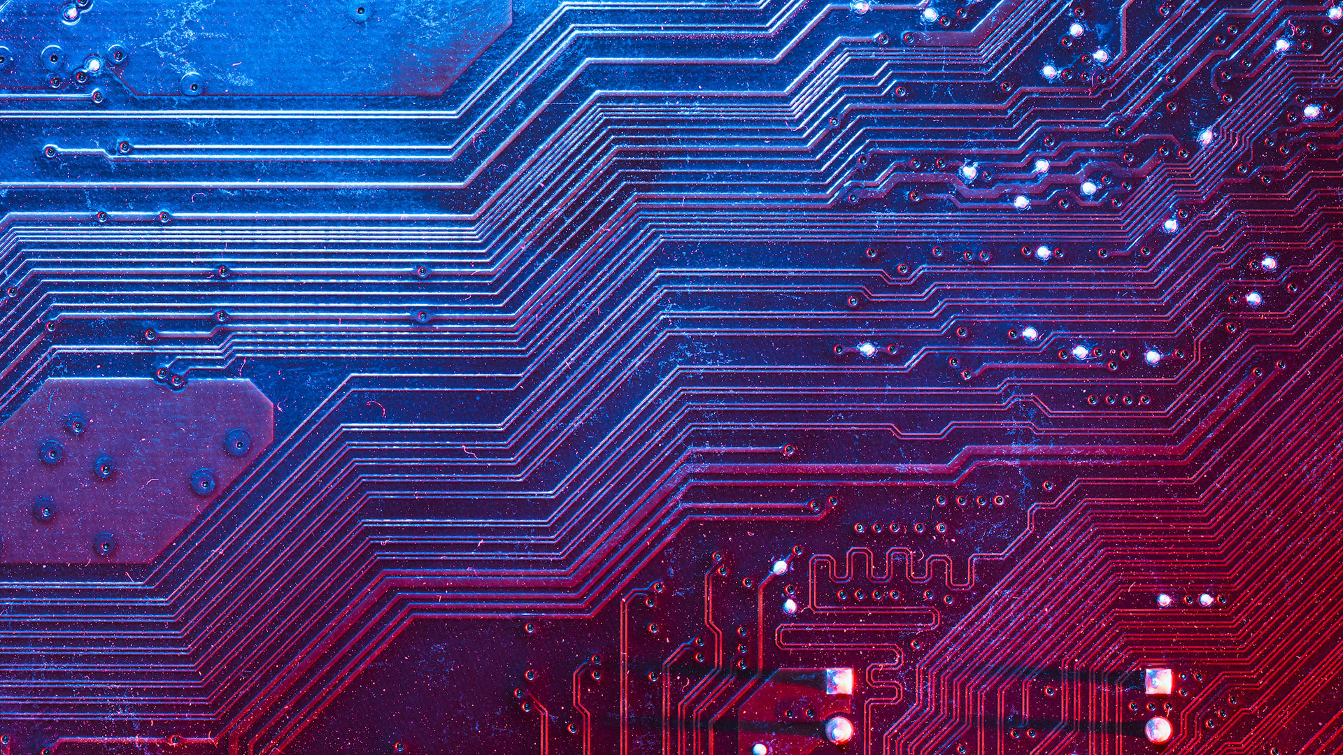 Electronic circuits and logic gates of a computer motherboard are pictured in a spot-lit, macro-photo view at the University of Wisconsin–Madison on April 17, 2026. Photo by Jeff Miller / UW-Madison.